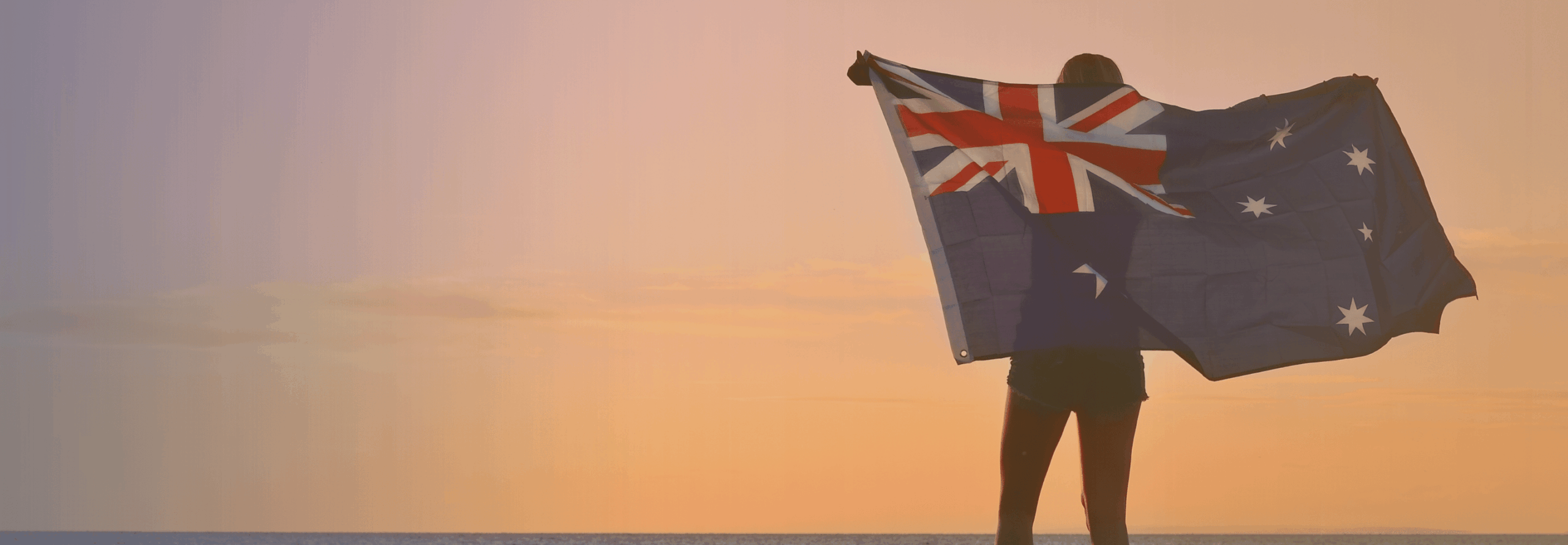 Supporters holding Save Australia Day signs at a public rally